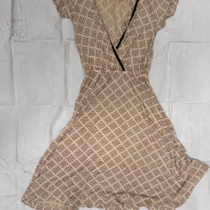 Full view of beige and brown Blevin wrap dress laid flat, showcasing flutter sleeves and wrap shape