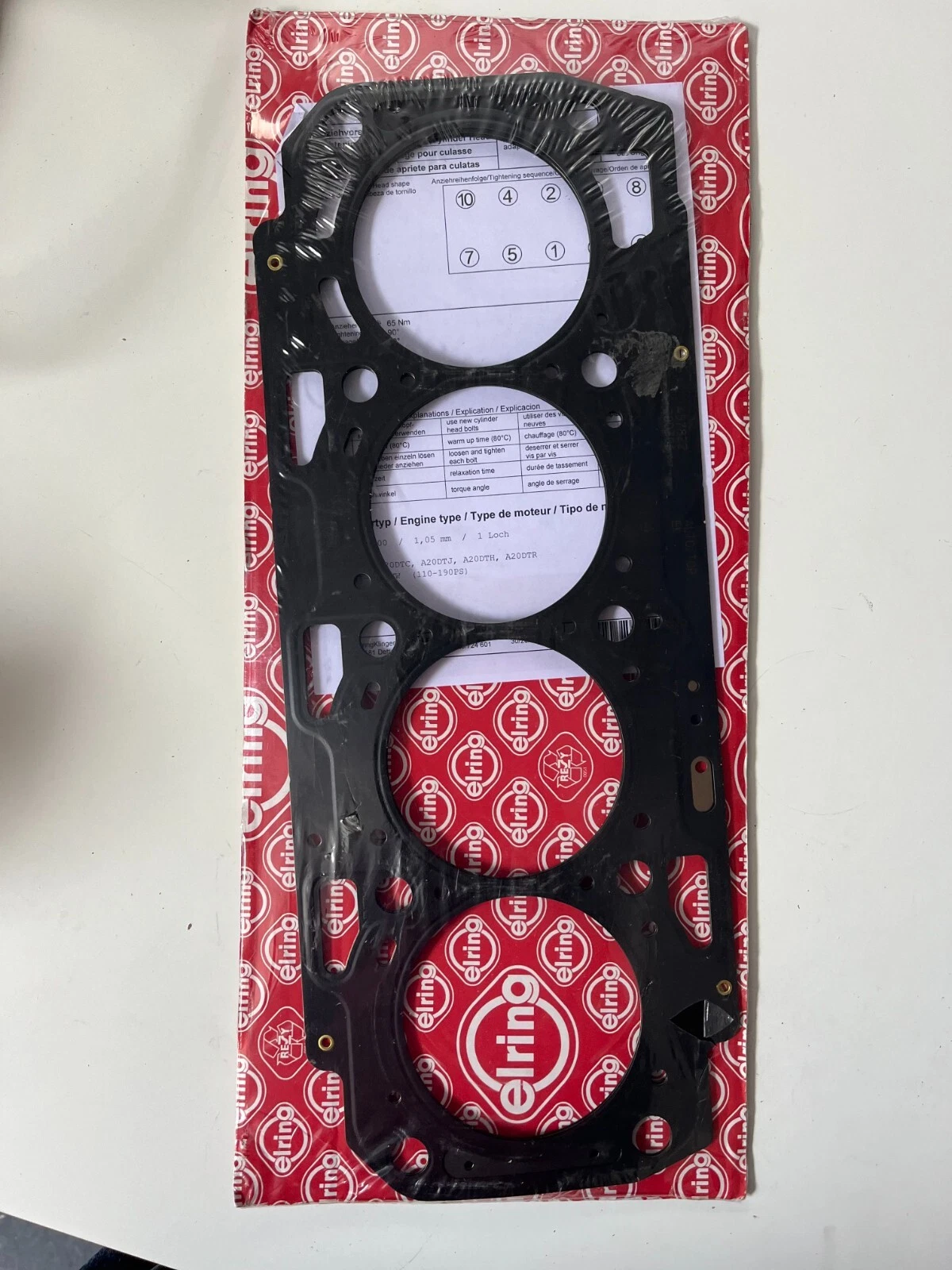 Front view of Elring 457.822 cylinder head gasket in packaging showing sealing ring positions