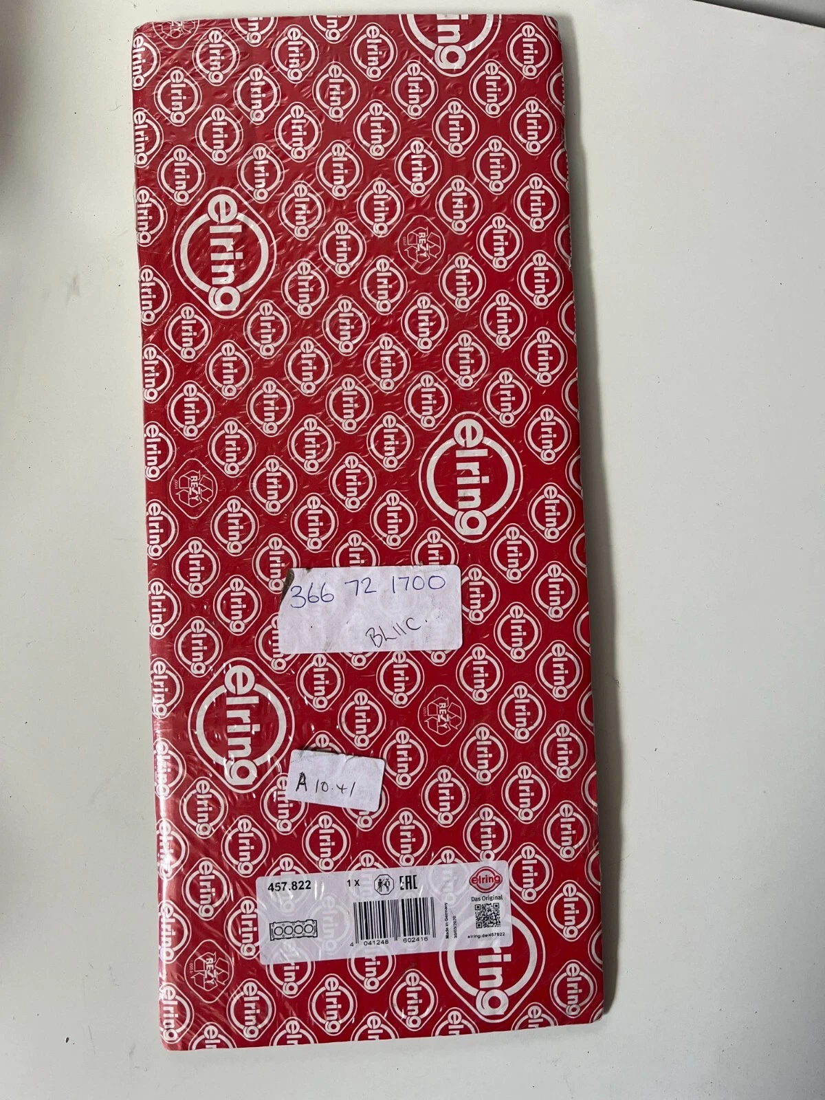 Back view of Elring packaging showing barcode, part number and handwritten stock labels