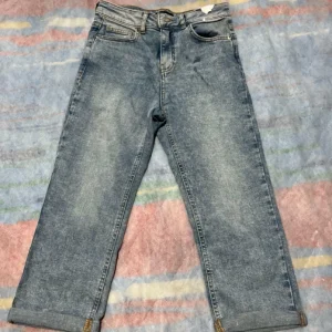 F&F ladies blue cuffed ankle bootcut jeans size 8 laid flat, front and label visible.