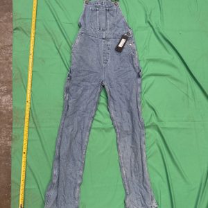 Full-length view of Nasty Gal carpenter dungarees with measuring tape beside